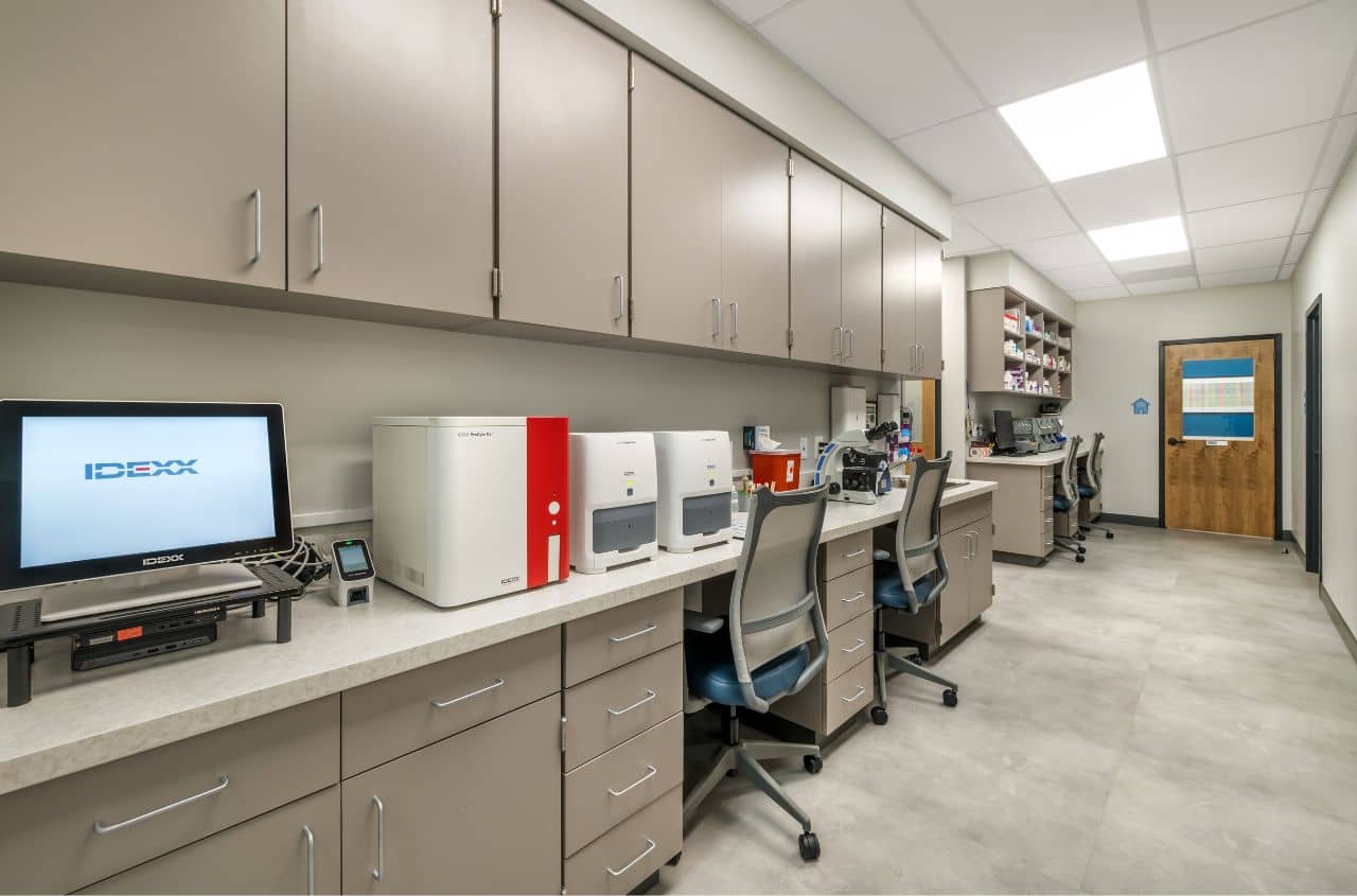 An empty technician area lined with desk chairs