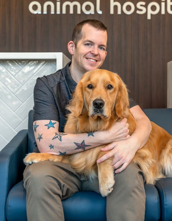 Jarrod Watson, Livewell Animal Hospital at the Parks Hospital Manager posing with dog