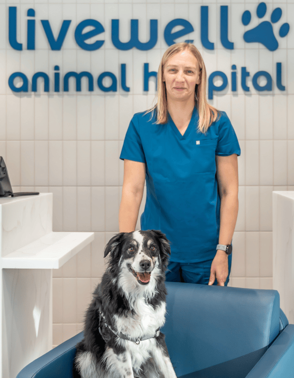 Lead DVM Stacie Coleman smiling with dog